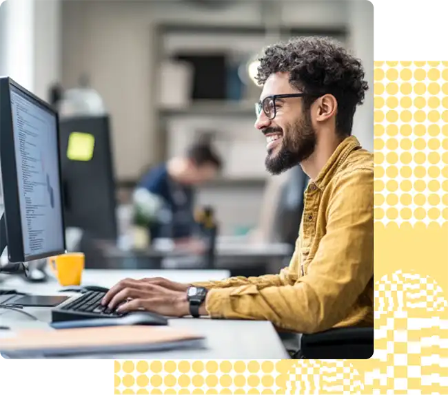 Man chatting at a computer with glasses and a smile on his face.